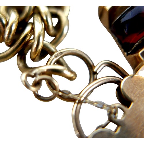 15 - A 9ct gold charm bracelet with heart lock, circular gold Taurus charm, wishbone charm, carriage with... 