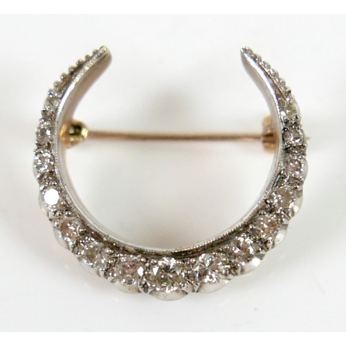 51 - A Victorian 9ct gold and diamond crescent shaped brooch, set with fifteen graduated diamonds, the la... 