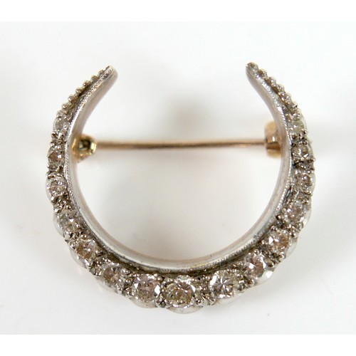 51 - A Victorian 9ct gold and diamond crescent shaped brooch, set with fifteen graduated diamonds, the la... 