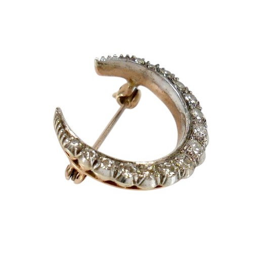51 - A Victorian 9ct gold and diamond crescent shaped brooch, set with fifteen graduated diamonds, the la... 