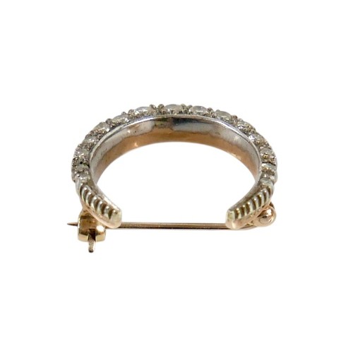 51 - A Victorian 9ct gold and diamond crescent shaped brooch, set with fifteen graduated diamonds, the la... 