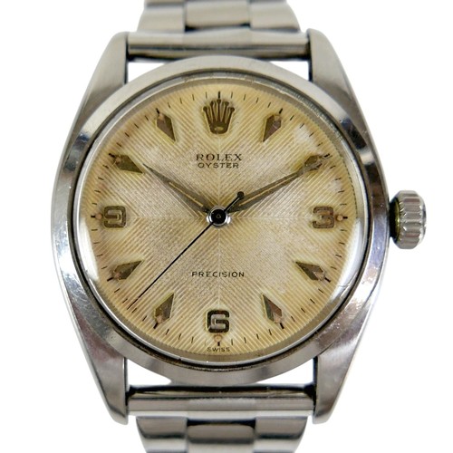 A Rolex Oyster Precision stainless steel gentleman's wristwatch, ref. 6422, circa 1957, champagne dial with quartered sunburst guilloche ground, Arabic 3, 6 and 9 numerals and gilt arrowhead hour markers, silver and luminous hands and centre seconds, 17 jewels movement, cal. 1210, serial N61083, case 35mm, 19mm between lugs, on a later stainless steel 'Expandro' bracelet strap with deployment clasp, 68.5g.
Notes: in working condition, winds and hands set well, keeps time across 1hr test, however Batemans cannot guarantee its continued operation.