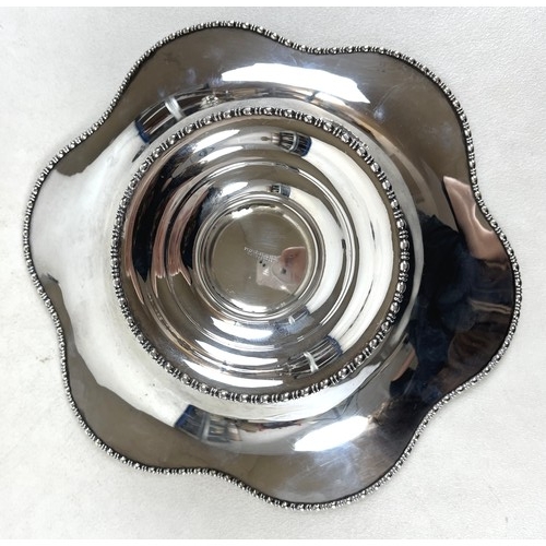 119 - A George V silver footed bowl, with a shaped top engraved with garlands, Stephenson & Sons, Sheffiel... 