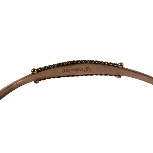 41 - An Edward VII rose gold hinged bangle, set with a row of four round faceted cut sapphires and seed p... 