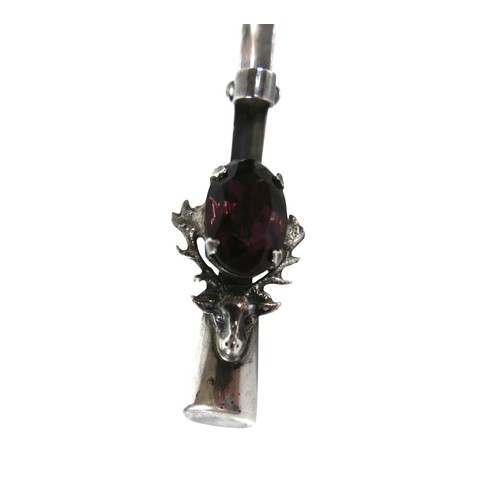 18 - A vintage Scottish silver brooch, set with an oval cut amethyst, 15.5 by 10 by 5mm, in the horns of ... 
