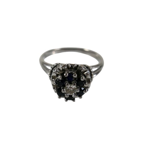 46 - A group of four white metal rings, comprising one set with a row of six marquise cut emeralds, each ... 