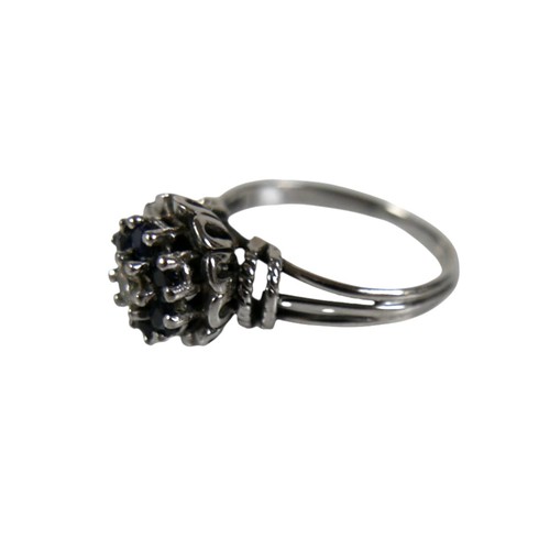 46 - A group of four white metal rings, comprising one set with a row of six marquise cut emeralds, each ... 