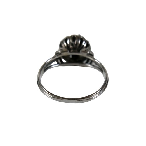 46 - A group of four white metal rings, comprising one set with a row of six marquise cut emeralds, each ... 