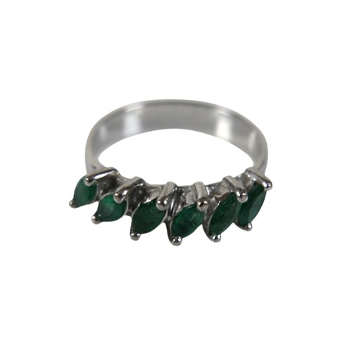 46 - A group of four white metal rings, comprising one set with a row of six marquise cut emeralds, each ... 