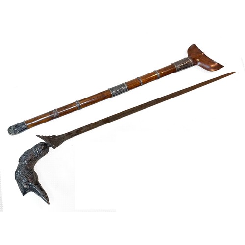 226 - An Indonesian Kris, ornate bird form pommel, blade length 53cm, its scabbard with metal mounts, over... 