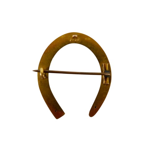 56 - A 15ct gold horseshoe brooch, with base metal pin, 3.8g overall. 3.2 by 3.5cm.