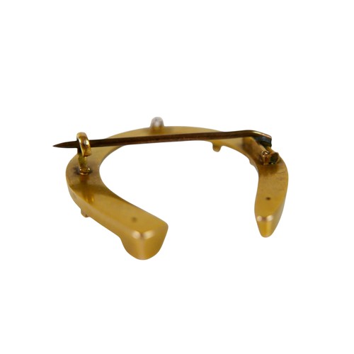 56 - A 15ct gold horseshoe brooch, with base metal pin, 3.8g overall. 3.2 by 3.5cm.