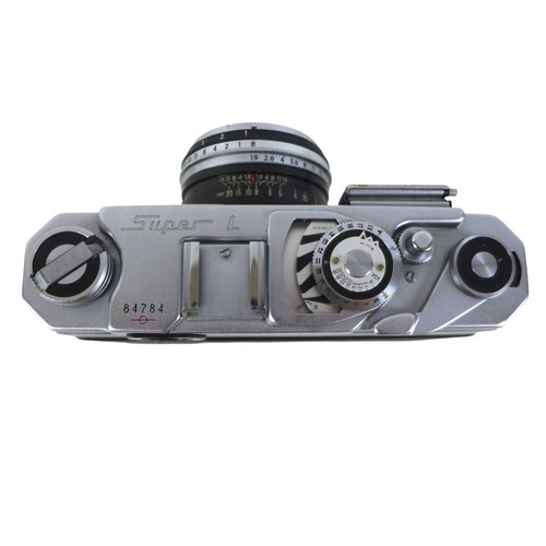 169 - A collection of nine vintage cameras comprising a Polaroid land camera, Voigtlander Vito B and Promi... 