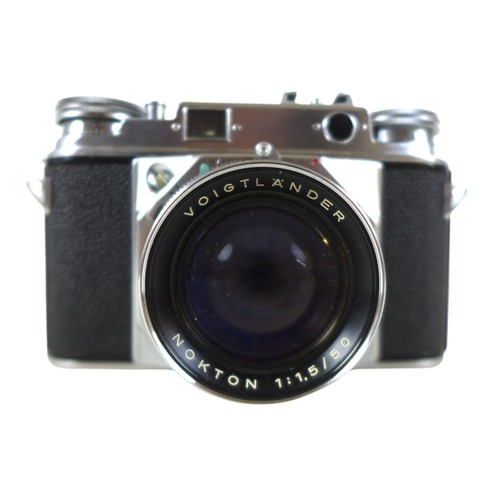 169 - A collection of nine vintage cameras comprising a Polaroid land camera, Voigtlander Vito B and Promi... 