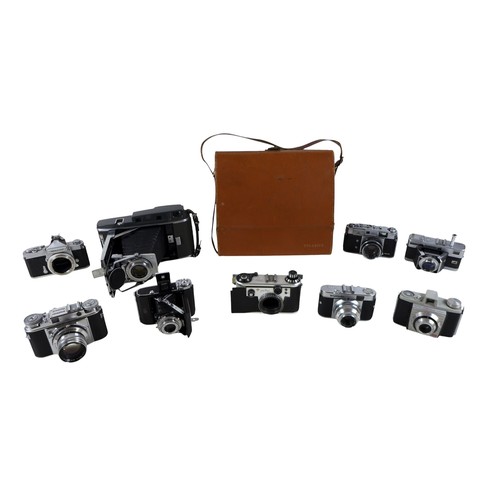 169 - A collection of nine vintage cameras comprising a Polaroid land camera, Voigtlander Vito B and Promi... 