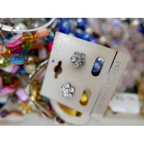 26 - A large collection of assorted costume jewellery and watches. (3 trays)