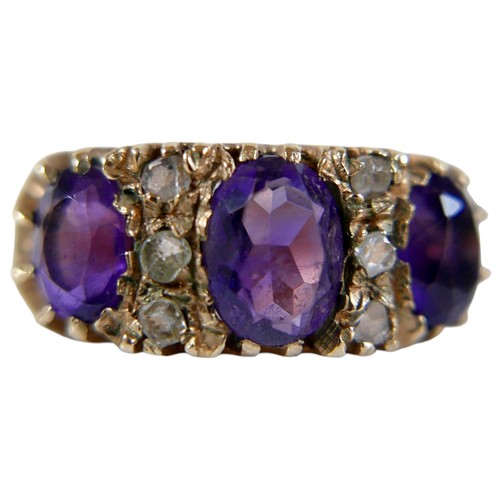 58 - A 9ct yellow gold amethyst and diamond ring, set with three oval cut amethysts and six small diamond... 