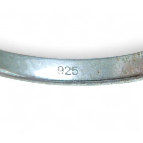 24 - A diamond and silver solitaire ring, oval style cut stone approximately 6 by 8mm, size O, 2.1g.