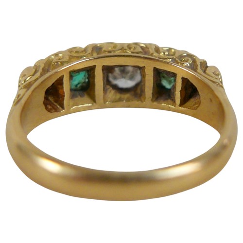 15 - An 18ct yellow gold five stone emerald and diamond ring the central diamond approximately 0.25ct, si... 