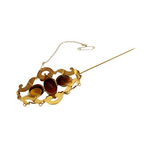 36 - A 19th century gold plated brooch with three oval citrine / brown stones, safety chain, 6cm by 3.5cm... 
