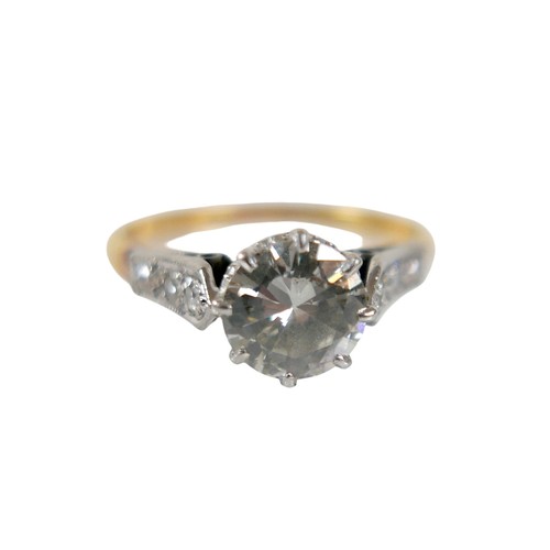 1 - An 18ct gold, platinum and diamond ring, the central brilliant cut diamond approx 1.6ct, each should... 