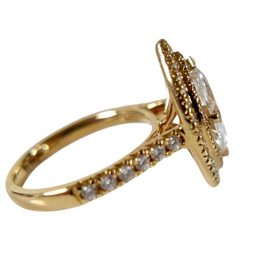 1 - An 18ct yellow gold and diamond ring, set with a 1.0ct marquise cut diamond, 9.8 by 5.4 by 3.3mm, co... 