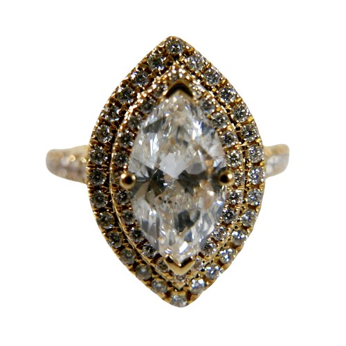 1 - An 18ct yellow gold and diamond ring, set with a 1.0ct marquise cut diamond, 9.8 by 5.4 by 3.3mm, co... 
