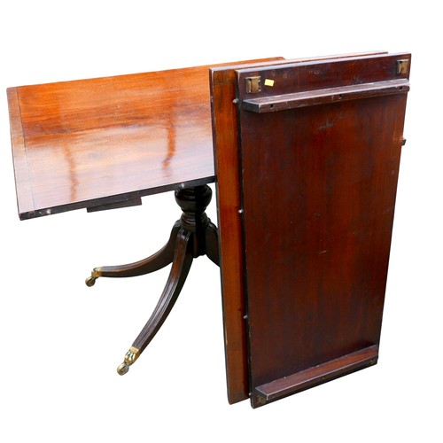 450 - A Regency style mahogany triple pedestal dining table, with cross banded decoration, raised on turne... 