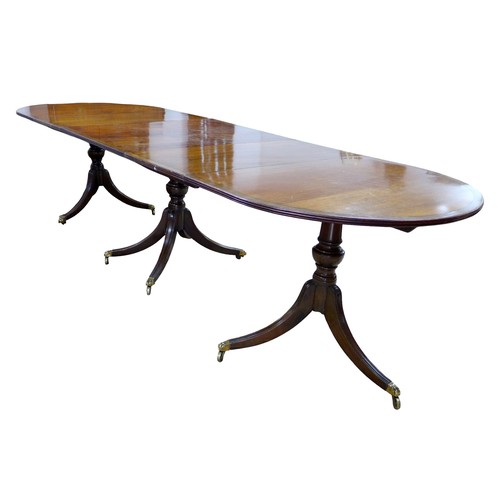 450 - A Regency style mahogany triple pedestal dining table, with cross banded decoration, raised on turne... 