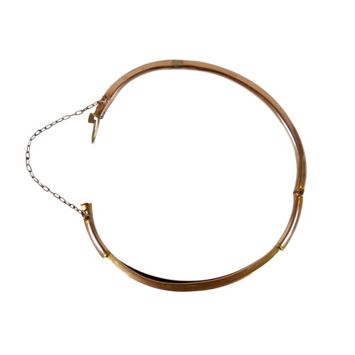 50 - A 9ct yellow gold diamond and ruby hollow bangle 6 x 6.5cm, weight 4.7g, with box.