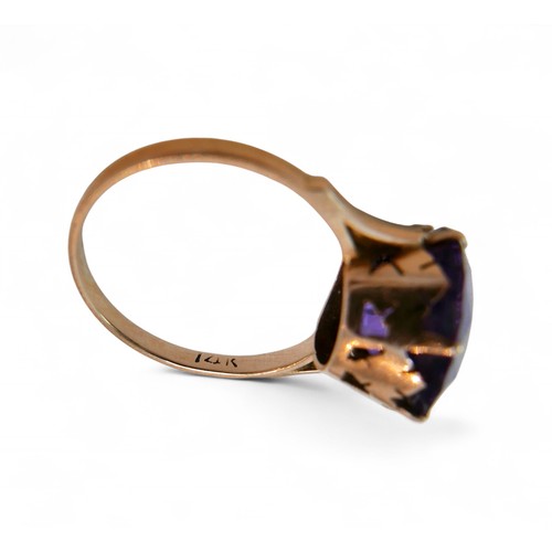 41 - A 14ct gold amethyst ring, the single round cut stone 1.2mm diameter, size N, 3g.