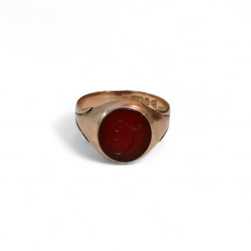 33 - A 9ct gold and a red stone inlaid signet ring, size P, 4.2g.