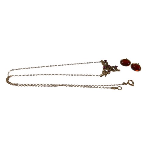 48 - A 9ct yellow gold ruby necklace and a pair of 9ct earrings the necklace head of foliate form 16 x 15... 