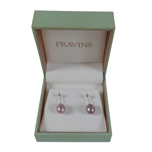 24 - A pair of 18ct white gold pearl earrings retailed by Pravins, pearls have a pink hew measuring 8 x 1... 