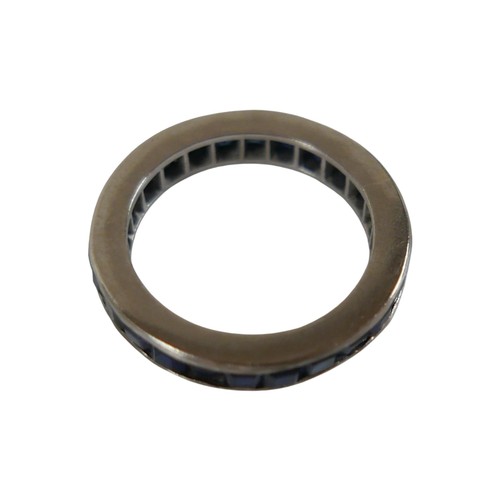 55 - A white metal sapphire eternity ring size O, 3.6mm band, weight 4.3g.