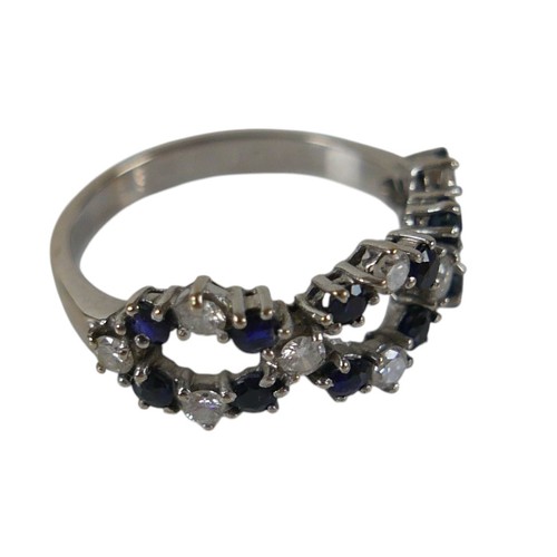 57 - An 18ct white gold diamond and sapphire ring set with twenty two interwoven stones, ring size O, wei... 