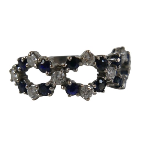 57 - An 18ct white gold diamond and sapphire ring set with twenty two interwoven stones, ring size O, wei... 