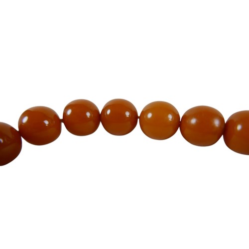 19 - A string of amber type beads 41cm long each 13mm diameter, total weight 52g.