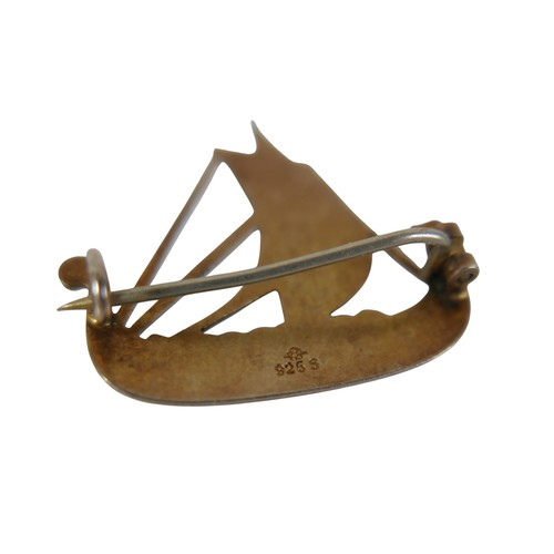 26 - Six pieces of enamel jewellery comprising a nurses buckle, single buckle, two ship brooches, a silve... 