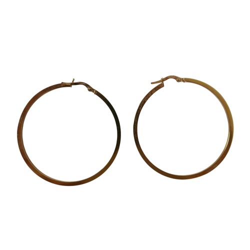 49 - Three pairs of 9ct gold earrings comprising a pair of white gold emerald studs, yellow gold hoop ear... 