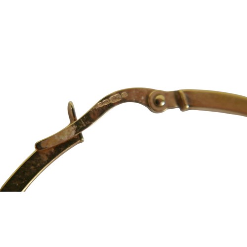 49 - Three pairs of 9ct gold earrings comprising a pair of white gold emerald studs, yellow gold hoop ear... 