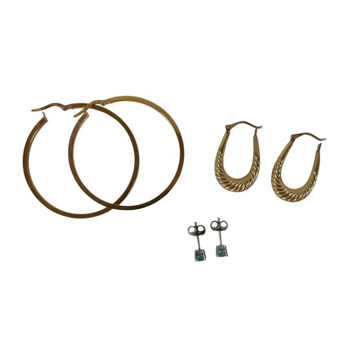 49 - Three pairs of 9ct gold earrings comprising a pair of white gold emerald studs, yellow gold hoop ear... 