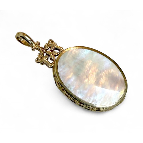 42 - A 9ct gold mother of pearl and hard stone inlaid pendant, 1.7 by 4cm, 7.9g.