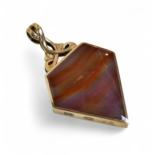 28 - A 9ct gold mounted ammonite shield form pendant, 3.5 by 6cm overall, 23.3g overall.