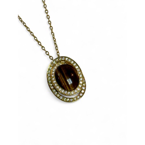 43 - A 18ct gold necklace with an 18ct gold tiger’s eye and diamond pendant, oval cut tiger's eye stone 1... 