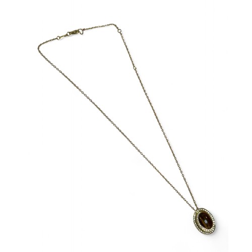43 - A 18ct gold necklace with an 18ct gold tiger’s eye and diamond pendant, oval cut tiger's eye stone 1... 