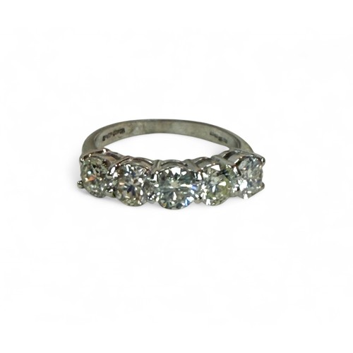 7 - An 18ct white gold five stone diamond ring, each stone approximately 5mm diameter, size Q, 5.4g.