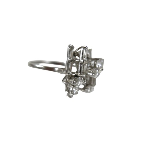 3 - A white gold and diamond set cluster ring, with a modernist asymmetric multi-level design, four marq... 