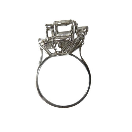 3 - A white gold and diamond set cluster ring, with a modernist asymmetric multi-level design, four marq... 