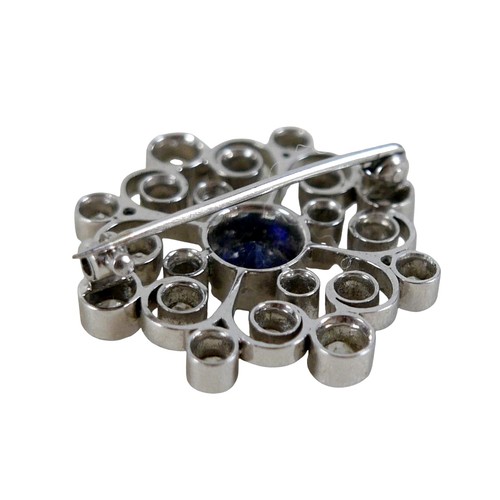 123 - A white metal sapphire and diamond flower head brooch the central sapphire approximately 1.0ct, surr... 